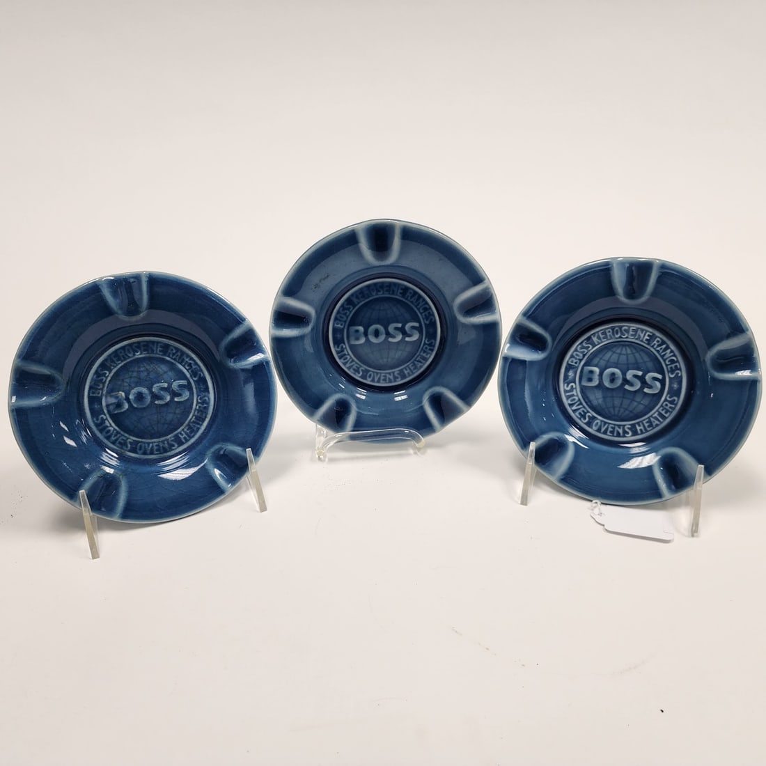 (3) Rookwood 'Boss" Ashtrays: (3) Rookwood pottery advertising ashtrays for the Boss company, (ranges, stoves, ovens, heaters), blue glaze, dated 1947, 5.75" dia