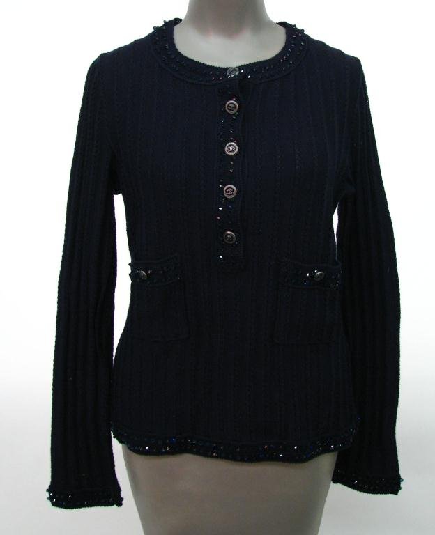 Chanel Navy Blue Ribbed Button Down Pull Over Swea: Chanel navy blue 100% cotton "ribbed" button down pull over sweater with sequin detailing at sleeves, neckline, hem and pockets and along the buttons; Collection 07P, Size 42