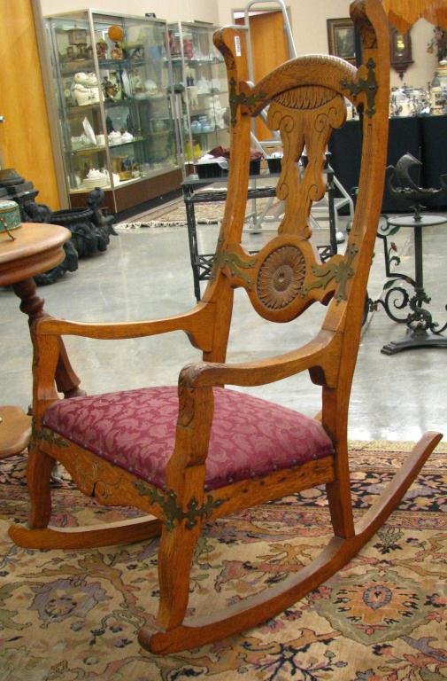 Unusual Antique Oak Rocking Chair: Unusual Antique Oak Rocking Chair with metal adornments and recessed carving with sun flower