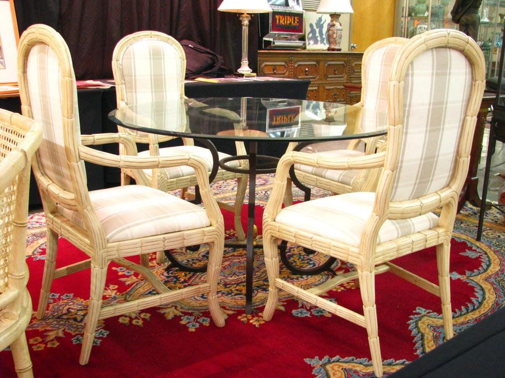 Glass Top Table and Four Chairs: Glass Top Table and Four Chairs, 48" table with cast metal base, and four rattan type carved arm chairs