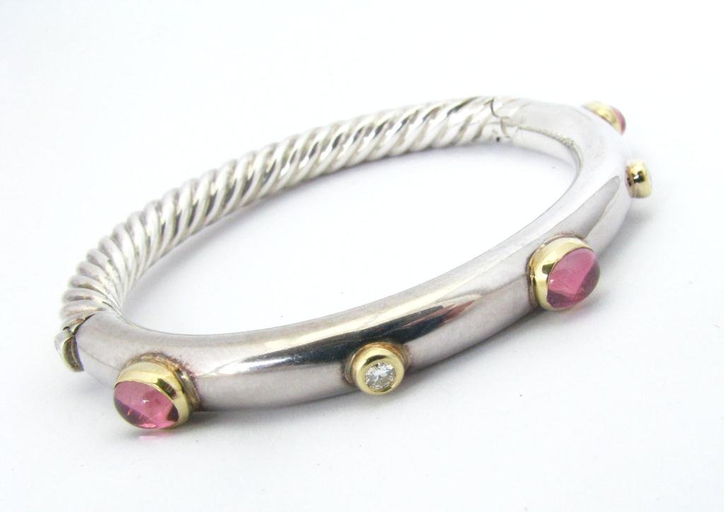 D. Yurman SS, 18K Tourmaline, Diamond Bracelet: A David Yurman, sterling and 18K yellow gold cable bangle bracelet with three oval pink tourmaline and two round diamonds, push clasp, approximately 7mm thickness, approximately 2.25" x 2" interior di