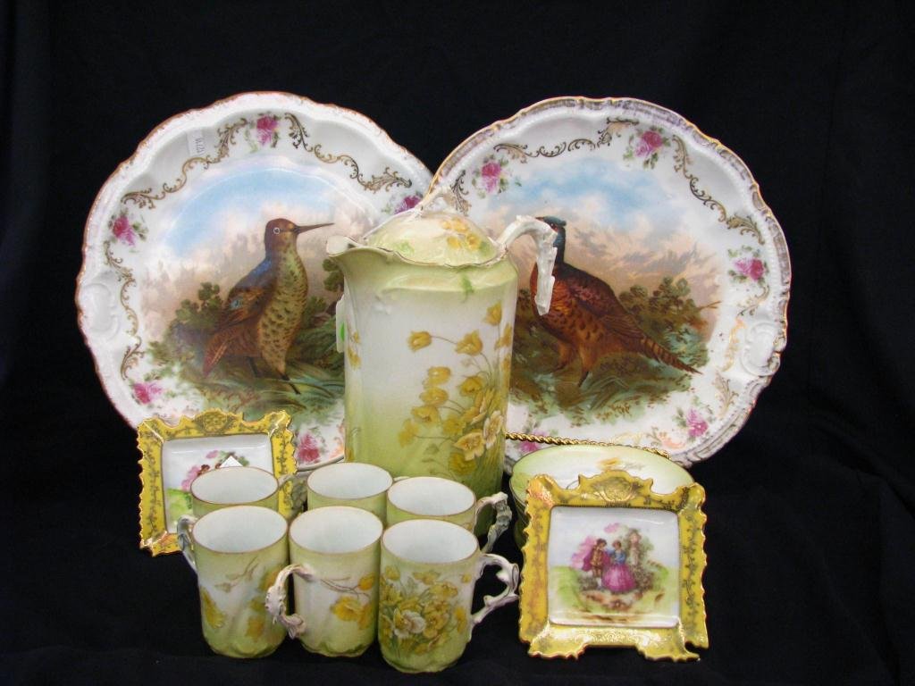 Group of European Porcelain: A group of European porcelain including two 11.5" Bavarian bird chargers, a Bavarian chocolate set with pot, six cups and six saucers (pot handle repaired), and two unmarked scenic pin dishes