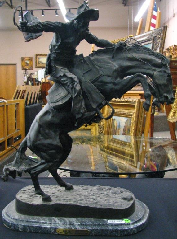 Cast Metal Remington Reproduction, "Bronco Buster": Cast metal Frederic Remington reproduction, "Bronco Buster", on marble plinth, 24" high, circa late 20th century
