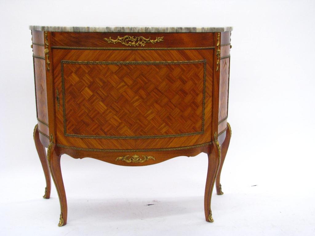 Vintage Louis XV French Style Commode: A vintage, Louis XV French style commode with marble top, cast ormolu mounts, and parquetry veneer