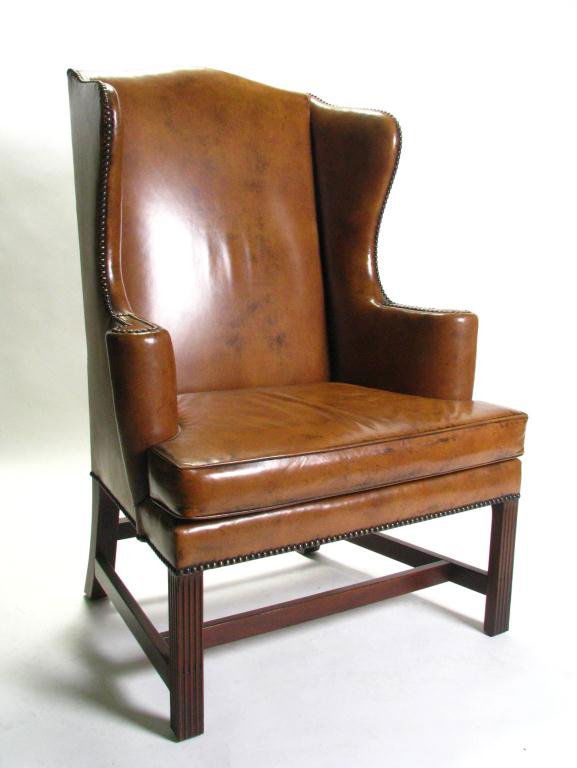 Vintage Kittinger Leather Fireside Chair: A vintage Kittinger leather fireside chair, Chippendale style, with nail head trim upholstery