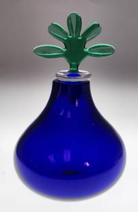 Venini Monofiore Sapphire Blue Bottle: A Venini Monofiore Sapphire Blue blown, handmade ampoule with stopper, #10041, circa 1994, by designer Laura De Santillana, featuring a rich sapphire blue glass with a blooming floret stopper. Made in