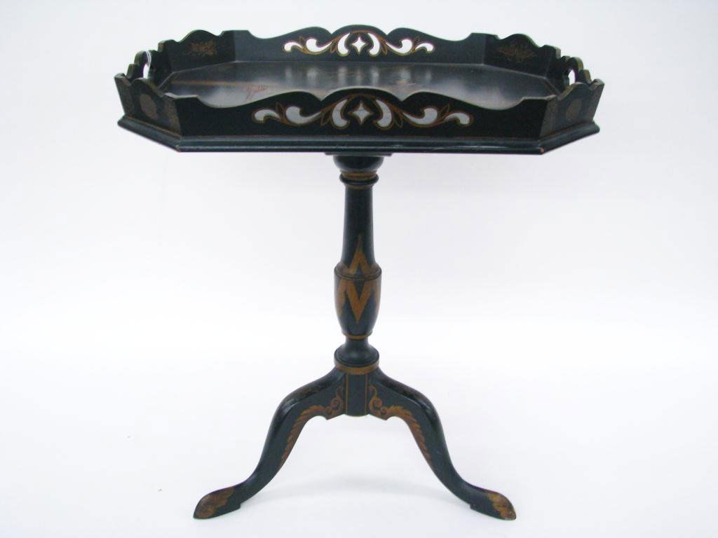 Oriental Chinoiserie Side Table: An Oriental chinoiserie side table, Queen Anne style bird foot tripod base, and embossed figures on t-tray style top, 27" high (minor finish ware from use).