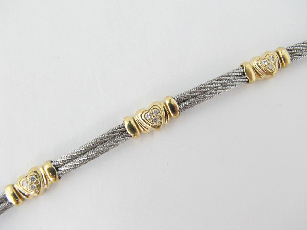 18K, Stainless Philippe Charriol Diamond Bracelet: A Philippe Charriol stainless double cable bracelet with 18K yellow gold heart accents, five hearts each with three round cut diamonds, 7" long, 9.7dwt