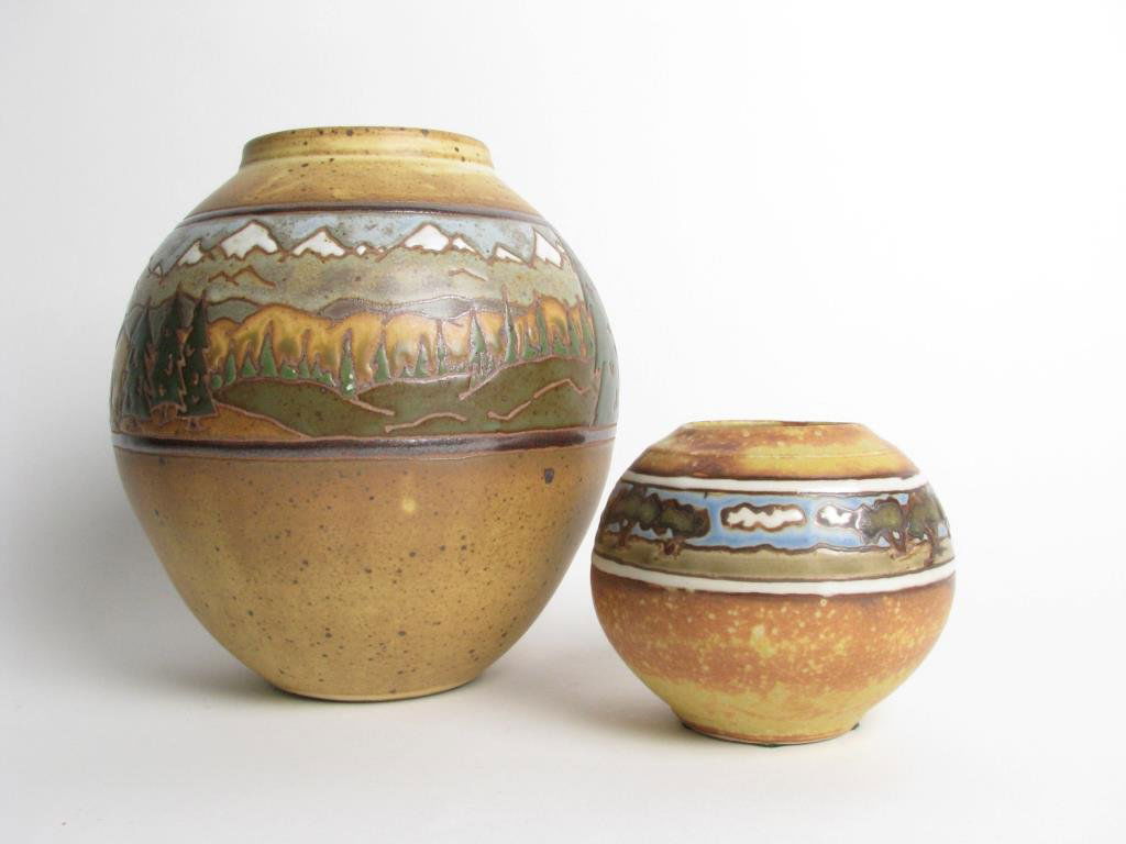 Two Handmade Landscape Vases: Two vases by Common Ground Pottery and Sassafrass Pottery, both handmade, one dated 2009 made by Common Ground Pottery, measuring 8" tall, depicts a snow tipped mountain landscape, the other measuring