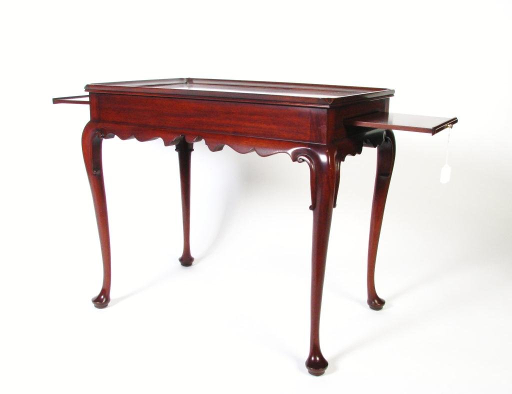 Henkel Harris Mahogany Tea Table: A Henkel Harris mahogany tea table, from the Virginia Galleries Collection of Reproduction 18th Century Furnishings, with two pullout trays, 26.5" high x 19" x 30"