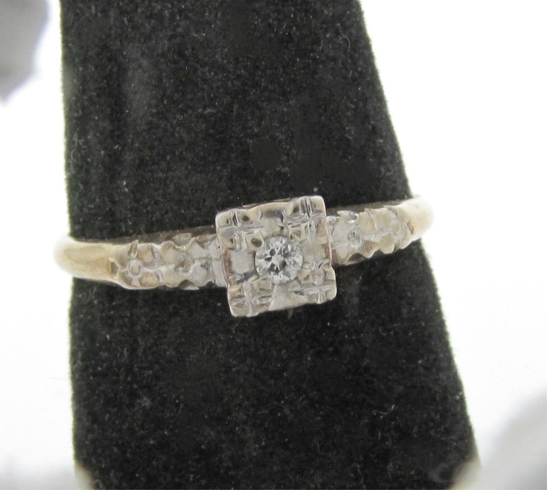 14K Yellow Gold Diamond Ring: A 14K yellow gold ring featuring an approximately .03ct round white diamond in a 14K white gold square mount. Ring size 7. Ring weight 1.2dwt.