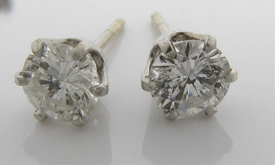 14K White Gold Diamond Stud Earrings: A pair of 14K white gold (tested, not marked) stud earrings, with each earring containing an approximately .63ct diamond solitaire of approximately I color and I1 clarity.