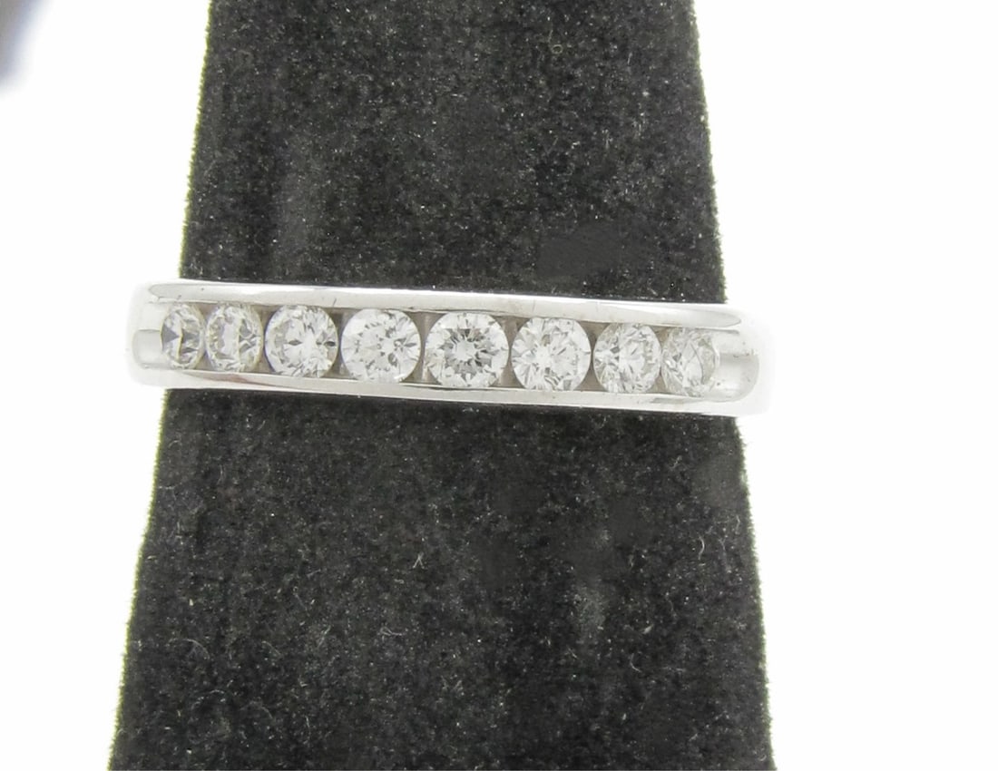 14K White Gold Diamond Anniversary Band Ring: A 14K white gold anniversary band ring containing eight round brilliant cut channel set diamonds of G-H color and SI1 clarity, weighing approximately .40ctw. Ring size 5.75. Ring weight 1.8dwt. Retail