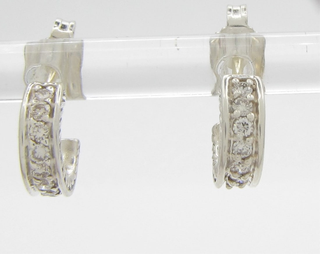 David Yurman Mini Cable Diamond Huggie Earrings: A pair of David Yurman sterling silver small/mini cable huggie earrings with sixteen diamonds weighing approximately .25ctw. Approximately .36" diameter.