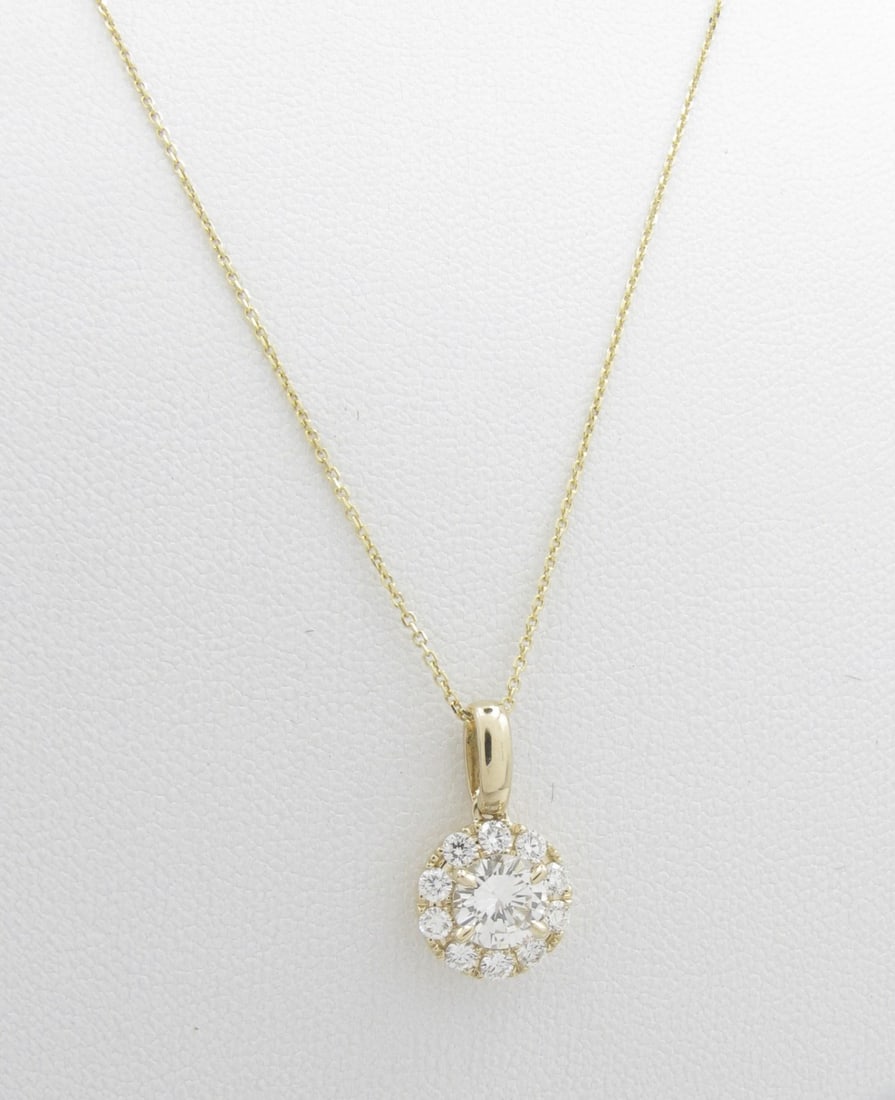 14K Yellow Gold Diamond Pendant, Chain: A 14K yellow gold round halo pendant featuring a .52ct round brilliant cut diamond of H-I color and SI clarity and .25ctw of round brilliant cut diamonds in halo style mounting, also of H-I color and