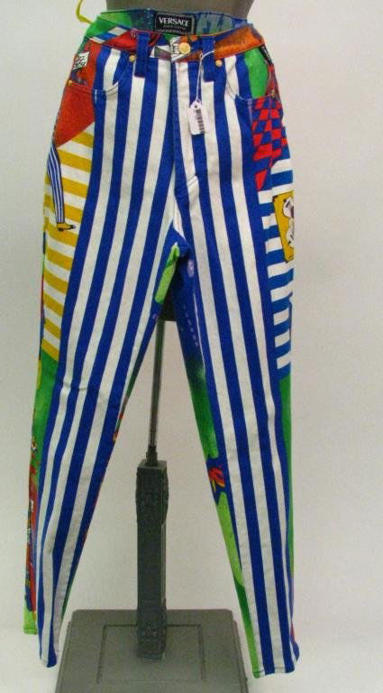 Versace Jeans Couture, Blue and White: Versace Jeans Couture rare vintage blue and white stripe with bright graffiti style pattern four pocket stretch denim jeans with medusa head studs and button; Size 29 (US 6)