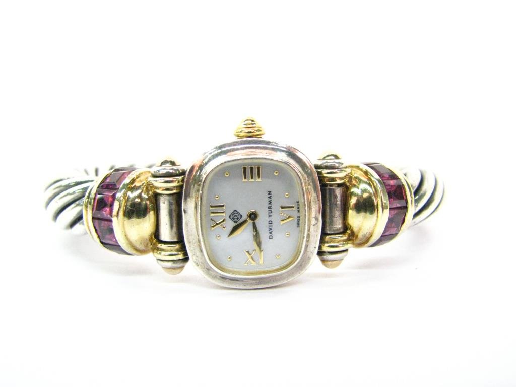 David Yurman, Sterling, 14K, Cable Wristwatch: David Yurman sterling silver, 14K yellow gold cable wristwatch with mother of pearl dial. The cable is 10 mm in width with 14K yellow gold stations set with rhodolite garnets. Hidden clasp. Case #T371