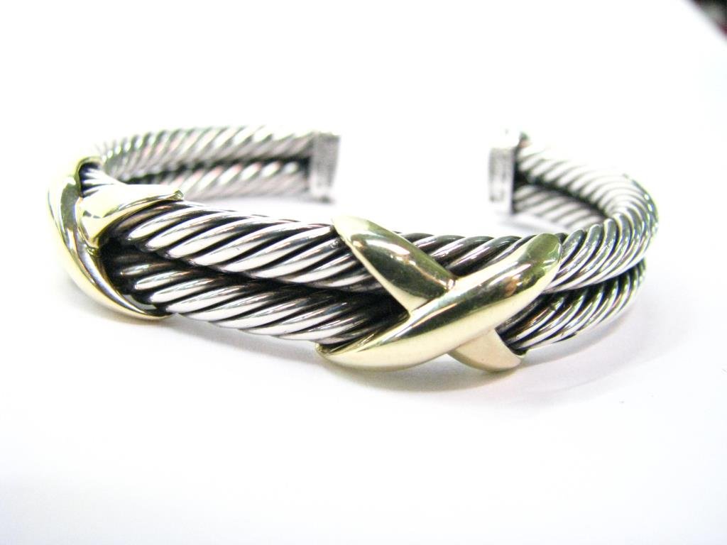 Yurman Sterling, 14K "X" Double Cable Bracelet: David Yurman sterling silver and 14K yellow gold "X" collection double cable bracelet. The bracelet features two cables that together are 10 mm in width and has two 14K yellow gold "X"s. Stamped D. Yu