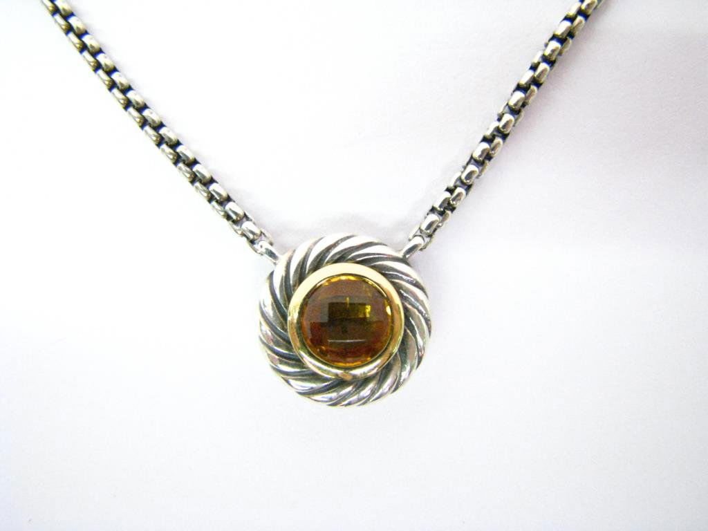 David Yurman, Sterling, 18K, Citrine Necklace: David Yurman sterling silver and 18K yellow gold citrine "cookie" necklace from the Color Classics Collection. Bezel set in the center is one faceted citrine. The pendant is attached to a 16" box link