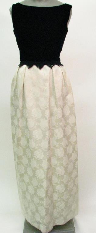 Black Velvet, Cream Floral Gown: Black velvet with cream floral skirt gown. Top of the dress is black velvet sleeveless design with straight neckline that is offset from the skirt with a fringe detail. The straight line skirt is crea