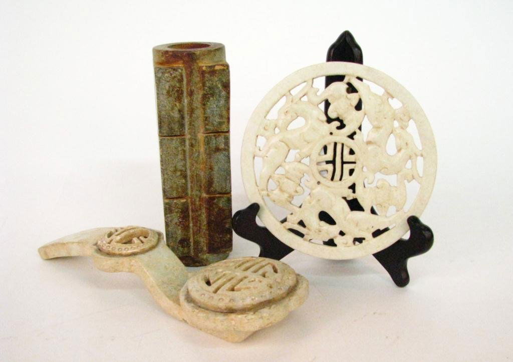 Group of Oriental Decorative Items: A group of Oriental carved stone decorative items, including 7.5" vase, 6.5" round trivet, and 11" curtain tie back, oriental pottery lidded box and tray, contemporary