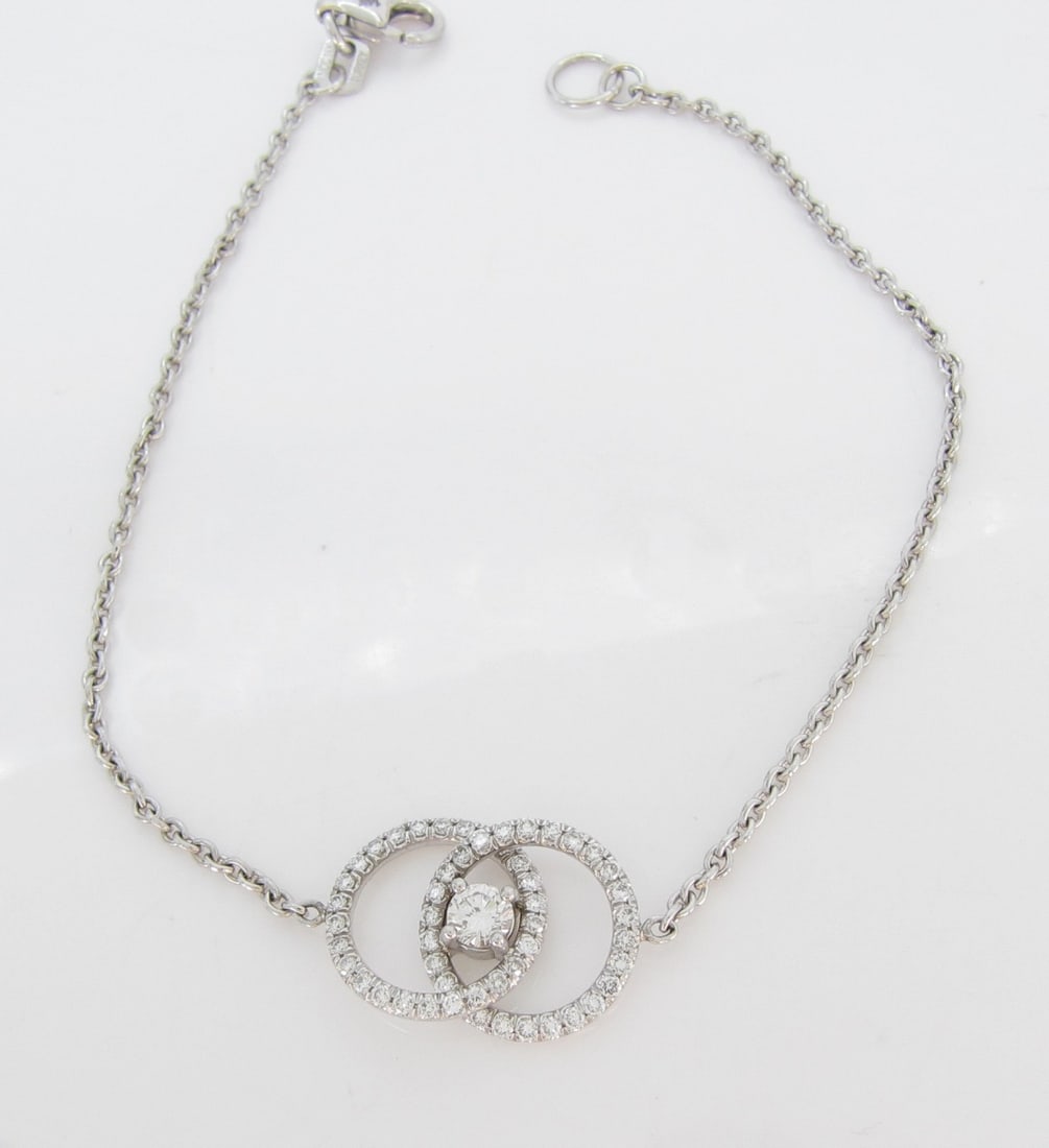 14K Yellow Gold Diamond Bracelet: A 14K yellow gold, 6.75" long link bracelet with two interlocking circle links pave set with .10ct of round diamonds in center. Total diamond weight approximately .50ctw. Bracelet weight 1.6dwt