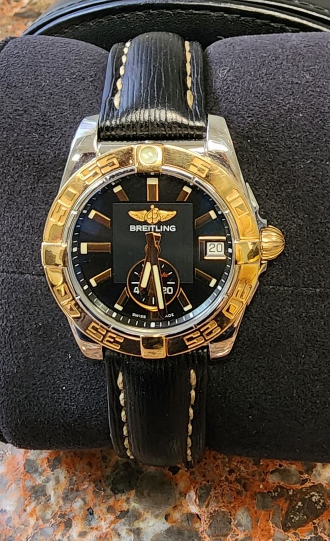 Breitling 18K/Stainless Galactic Watch, Automatic: A Breitling 18K and stainless steel Galactic 36mm watch, model #C37330, circa 2014, black dial, luminous tipped gold markers and hands, subdial at 6 o'clock, date at 3 o'clock, 18K gold bezel and