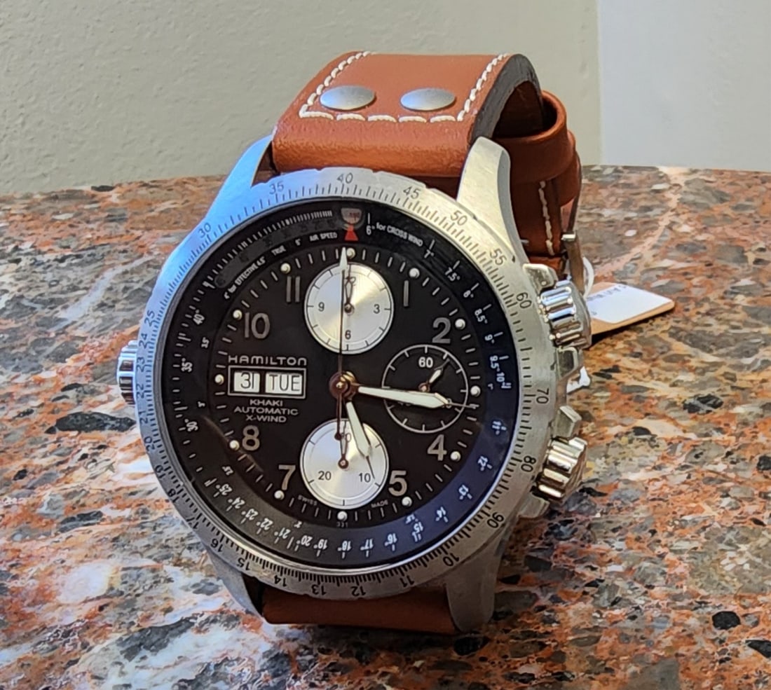 Hamilton Khaki Wind AVI Watch, 2025, Automatic: A Hamilton Khaki Wind AVI stainless steel watch, automatic movement, black dial, silver tone Arabic numeral markers, silver tone luminous filled hands, day/date at 9 o'clock, subdials at 12, 3 and 6