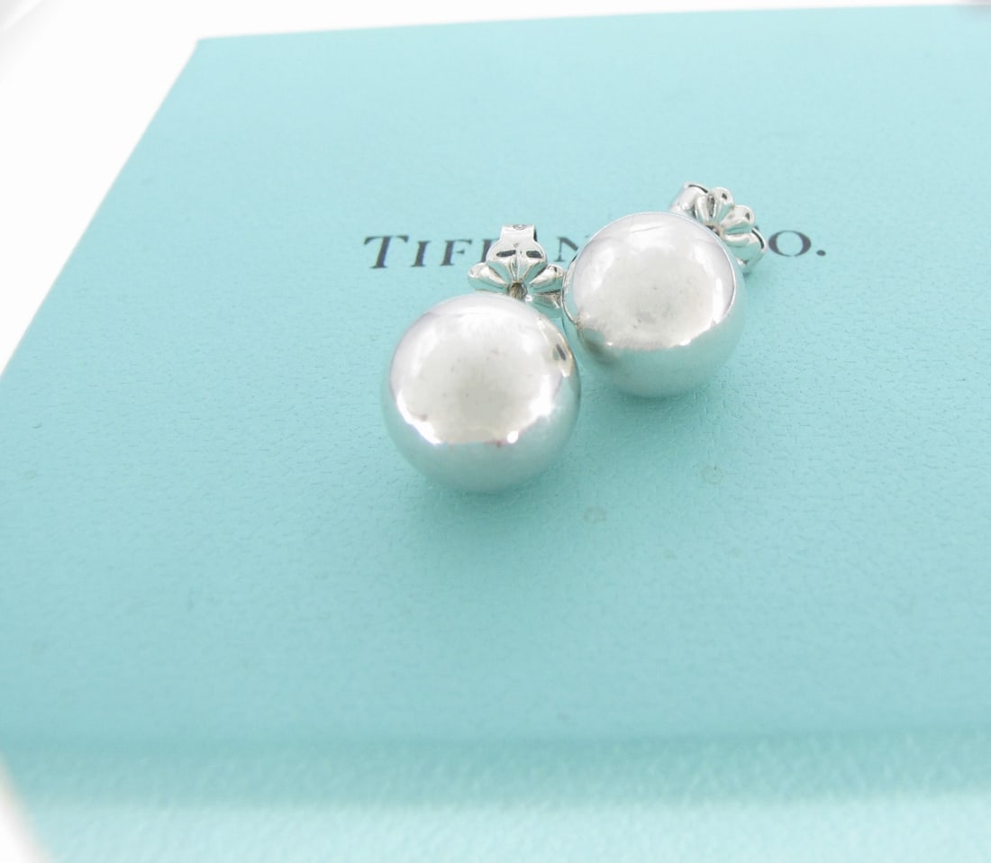 Tiffany & Co Sterling 10mm Ball Stud Earrings: A pair of Tiffany & Co. sterling silver 10mm ball stud earrings, with box and pouch.