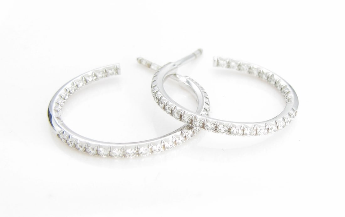 Tiffany & Co. 18K WG Diamond Hoop Earrings: A pair of Tiffany & Co. 18K white gold .875" diameter hoop earrings with approximately .50ctw diamonds. Approximately .88" diameter