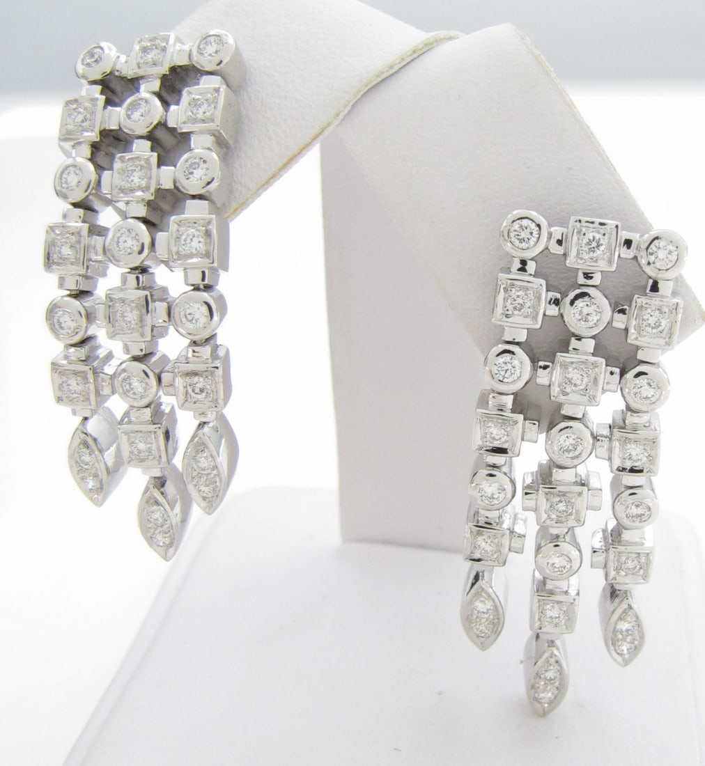 14K WG Fancy Diamond Dangle Drop Earrings: A pair of 14K white gold dangle drop earrings containing fifty round, brilliant cut diamonds weighing approximately .75ctw, set in square and marquise shaped links. Screw posts. Earrings weight
