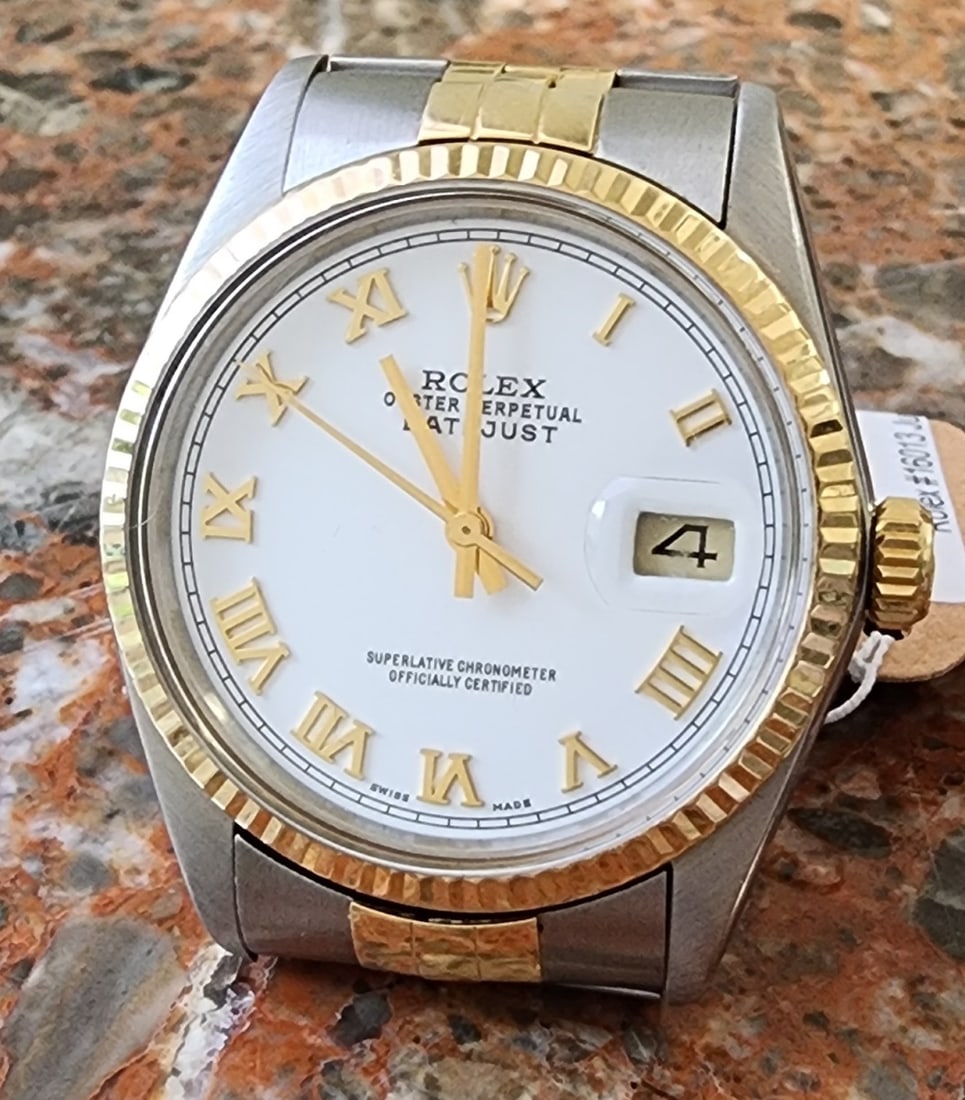Rolex #16013 Jubilee Bracelet 18K Watch: An 18K yellow gold and stainless steel Rolex watch, reference #16013, 36mm, white dial, gold Roman numeral markers, 18K fluted bezel, date at 3 o'clock, gold stick and seconds hands, 18K yellow gold
