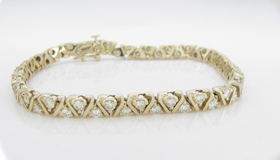 14K Yellow Gold Diamond Tennis Bracelet, 2.75CT: A 14K yellow gold V link tri-bar tennis bracelet with approximately 2.75CTW of round brilliant cut diamonds of SI2 to I1 clarity and H-I color. Approximately 7.5" long and 5mm wide. Bracelet weight