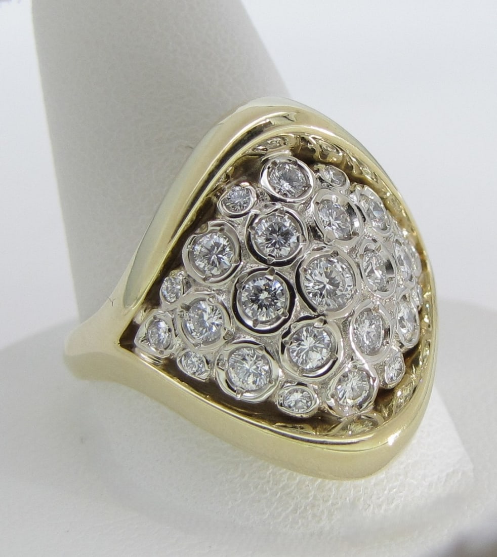 18K Yellow Gold 1CT+ Diamond Ring: An 18K yellow gold ring containing twenty-three diamonds of VS clarity and F-G color, pave set in white gold saddle style mount. Total diamond weight approximately 1.1ctw. Ring weight 8.6dwt. Size