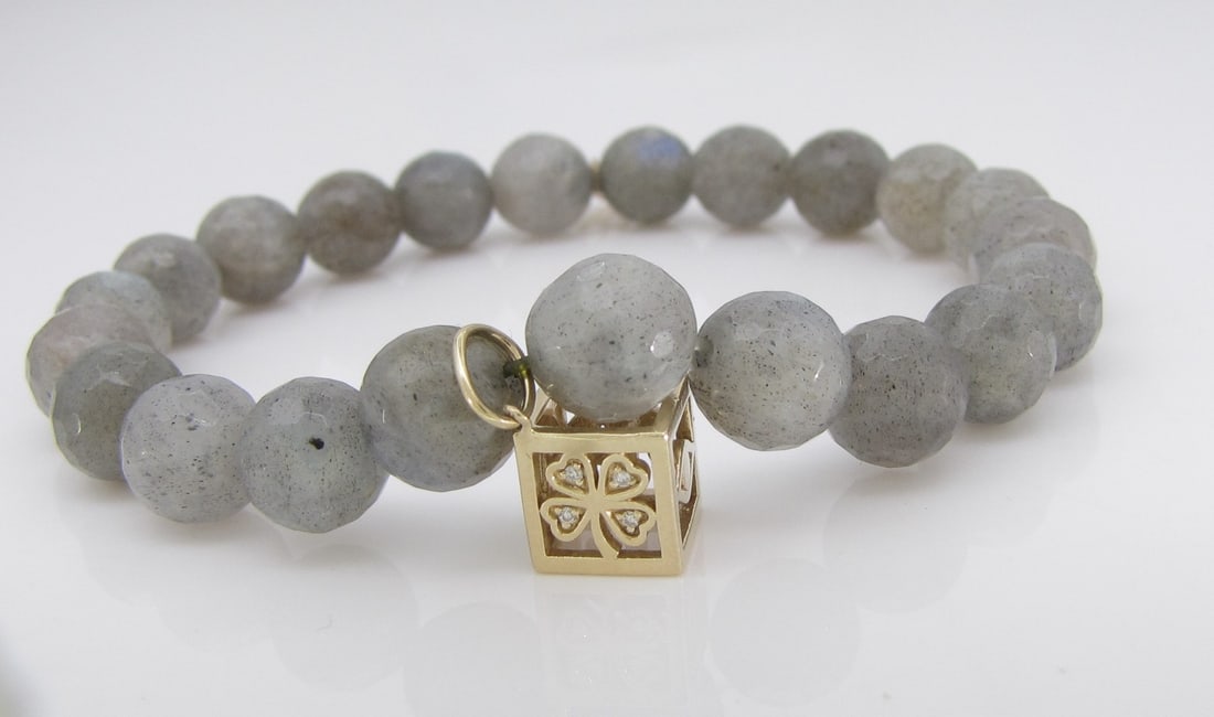 Sydney Evan Labradorite Bead Bracelet: A Sydney Evan 7mm faceted labradorite bead bracelet on stretch cord, with 14K yellow gold box good luck charm with evil eye diamond elephant, four leaf clover. Maximum interior circumference