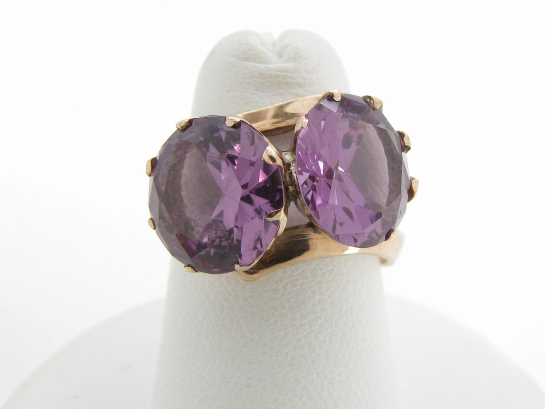Vintage 14K YG Ring: A vintage 14K yellow gold bypass style ring containing a 10mm round synthetic color change corundum . Ring weight 3dwt. Size 6.5.