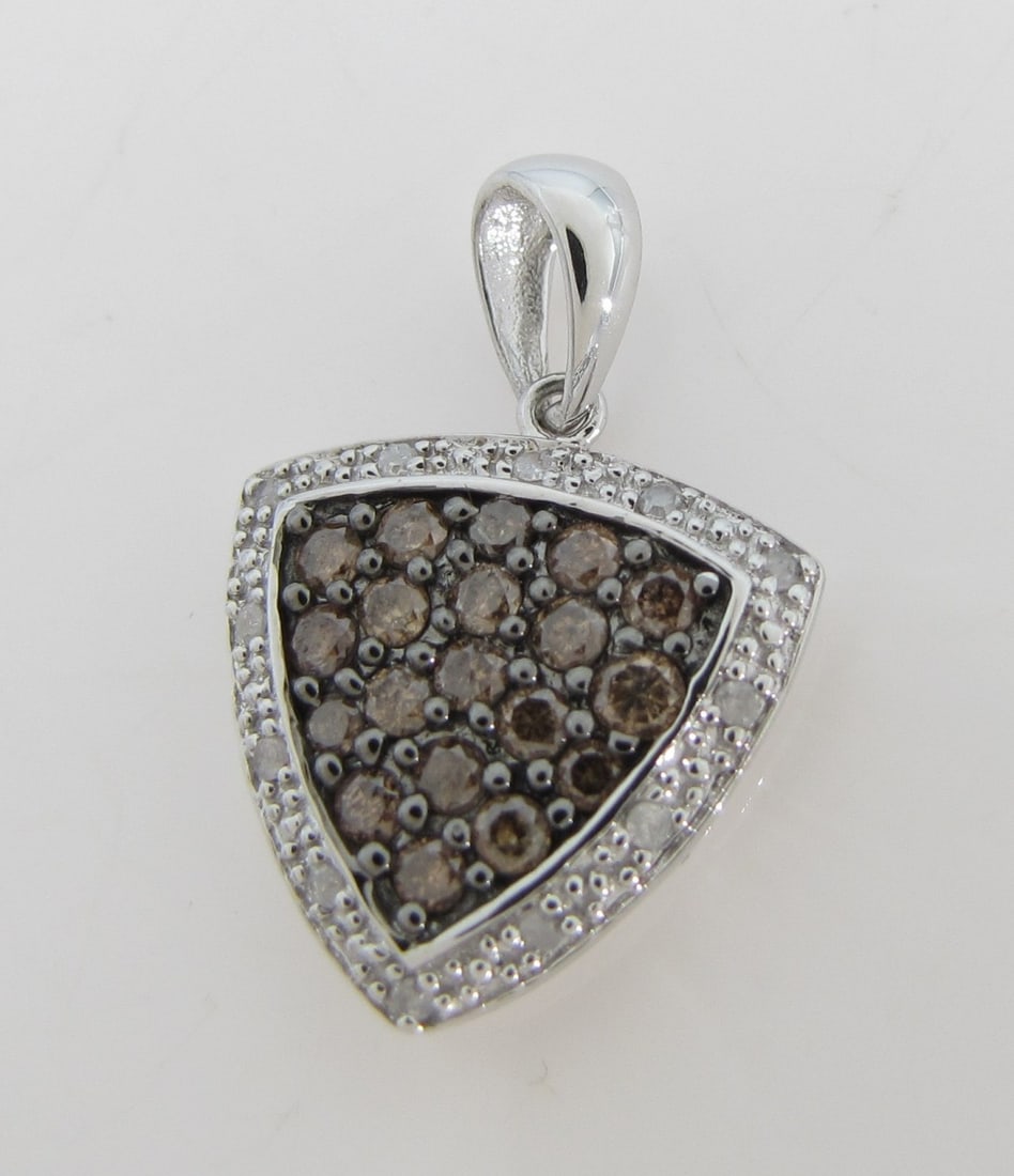 14K White Gold White/Chocolate Diamond Pendant: A 14K white gold trillion shaped pendant measuring approximately .9" x .6", featuring .59ctw of round white and chocolate pave set diamonds. Pendant weighs 1.6dwt.