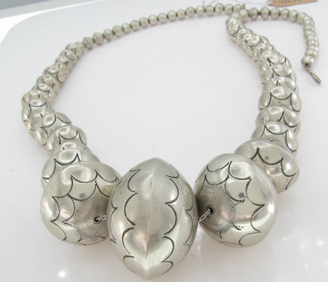 L.Y. Sterling Southwest Graduated Bead Necklace: A sterling silver, southwest design bench bead (Navajo Pearl) necklace signed 925 L.Y. (L. Yazzie?), measuring approximately 26" long, with silver Navajo "pearls" measuring from approximately