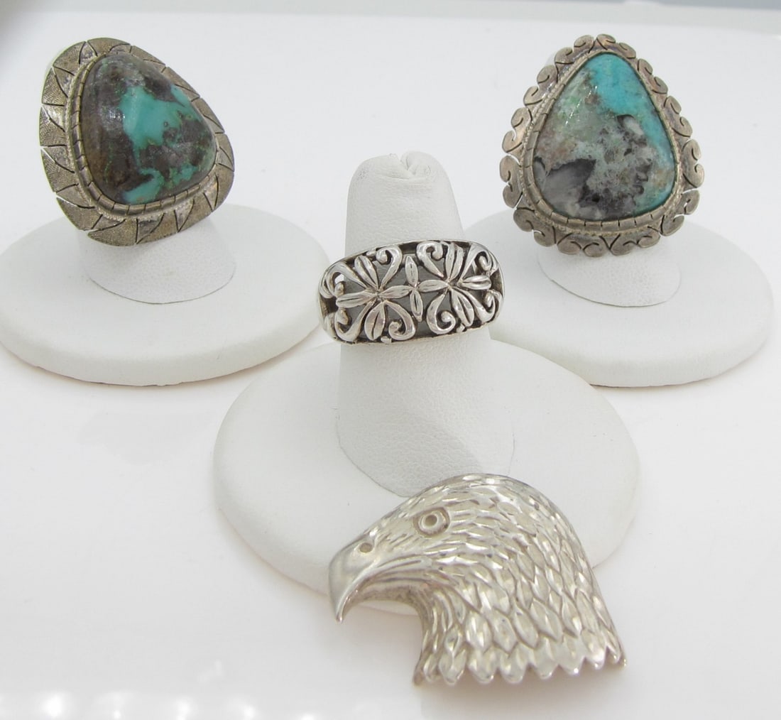Sterling Silver Rings and Pendant: A sterling silver eagle slide pendant, simply marked on hammered back "Sterling", approximately 1" x 1.25", 4.8dwt; a filigree scrollwork ring marked 925 Thai, size 7, 3.9dwt; and two cabochon