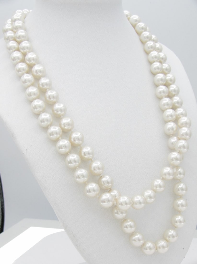 14K Ocean Treasures Double Strand Bead Necklace: A 14K yellow gold clasped double strand necklace with 8mm faux pearl beads, approximately 16" long. Clasped signed Ocean Treasures TM and marked 14KG