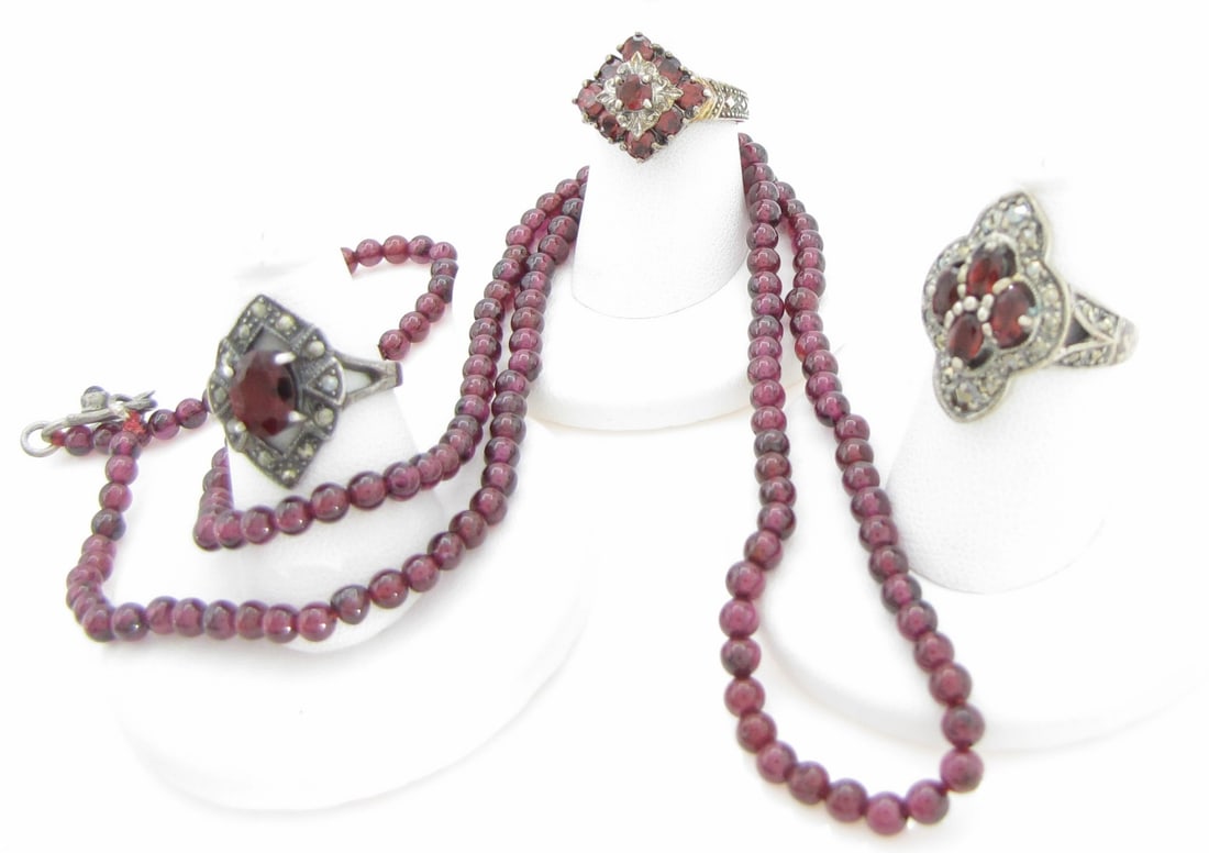 Sterling Garnet Stone Rings, Necklace: Three sterling silver rings including single oval garnet colored stone measuring 8.5mm x 6mm with marcasite marquis shaped mounting, size 5.75, 2.4dwt; a four-stone ring, with stones being of a