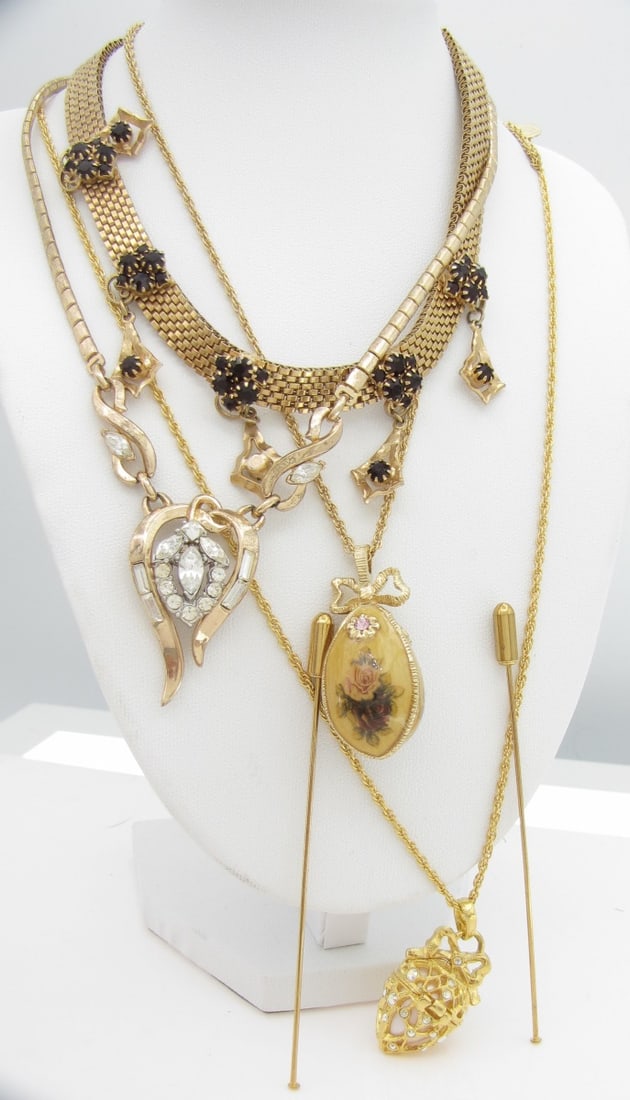 Group of Costume Necklaces, Trifari, Rivers...: A group of costume necklaces including a Joan Rivers "Secret of the Scroll" faberge-style egg locket, hinged, with pearlized egg pendant encrusted with Aurora Borealis rhinestones in a gold tone