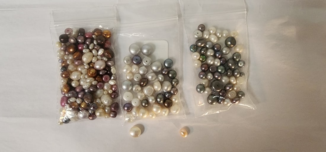 Loose Pearls: A bag of loose pearls including two retailer bags, each marked "Cult FW pearl" including gray, white and purple pearl beads drilled for string and a retailer bag marked "cult dyed mul-clr prl"