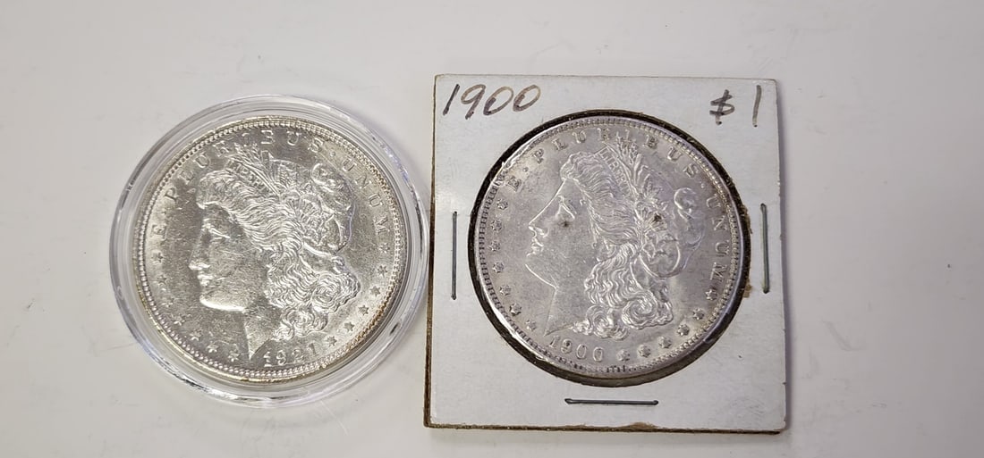 (2) US Silver Dollars, Morgan: (2) US Silver dollars, including 1900-NM, and 1921-D, both in very nice condition