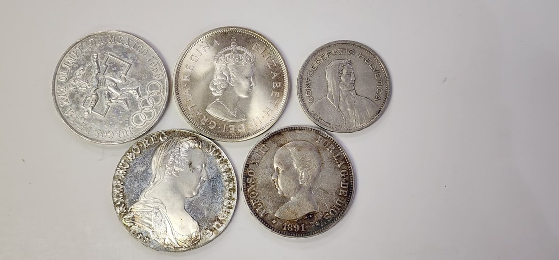 Group of Foreign Silver Coins: Group of Foreign Silver Coins, including .925 Bermuda 1959 One Crown, .900 1891 Spanish 5 pesatas coin , 1968 Mexicanos Olympics, .720 silver 25 Pesos coin, 1954 Swiss 5-Franc .835 silver coin, 1780