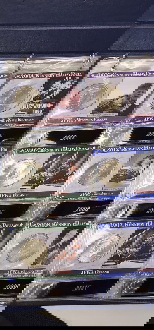 Collection of Kennedy Half Dollars: Collection of Kennedy Half Dollars, (42) total uncirculated coins, each year in individual display cards with defining moments in John F Kennedy's life, with Willabee & Ward display binder