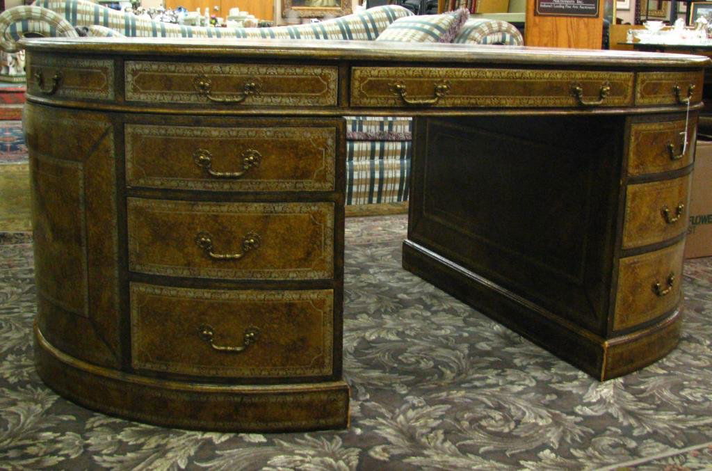 Vintage Maitland-Smith Leather Top Partner's Desk: A Vintage Maitland-Smith oval leather top partner's desk, with embossed decoration, and mottled glaze finish over entirety, circa Mid/Late 20th Century (shows some finish wear on one side), 30" high x