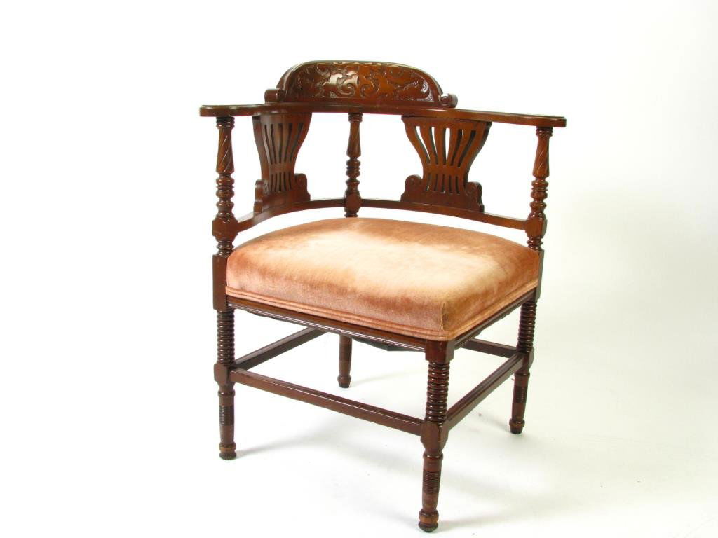Vintage Period Style Carved Corner Chair: A vintage Period style carved corner chair, with padded upholstered seat