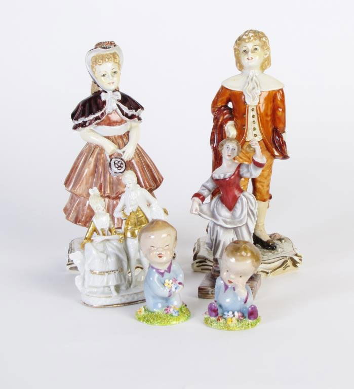 Group of Assorted Porcelain Figurines: A group of assorted porcelain figurines, including a pair of hand painted plastered figurines, woman and female (male has been repaired), a pair of Wade England porcelain baby figurines, including "Bl