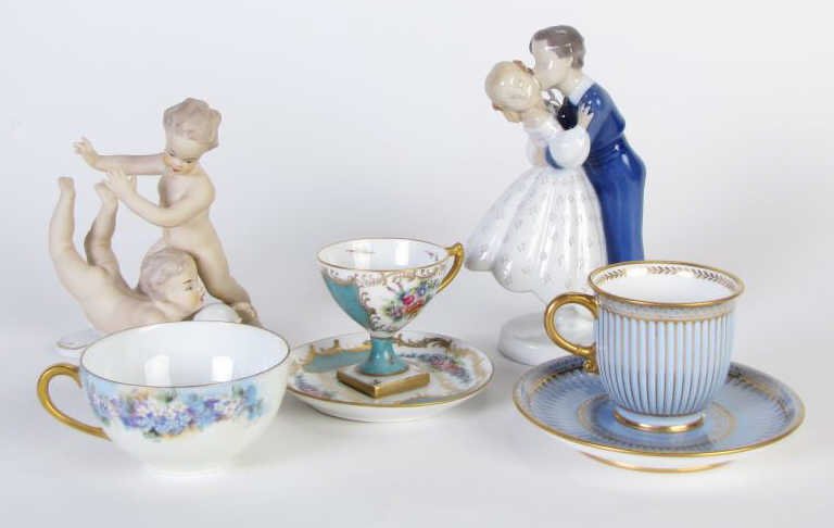 Group of European Porcelain: A group of European porcelain, including Limoges cup and saucer, two Sevres cups and one saucer, a Bing Grondahl figurine of romantic couple, and a German porcelain figural grouping, depicting childre